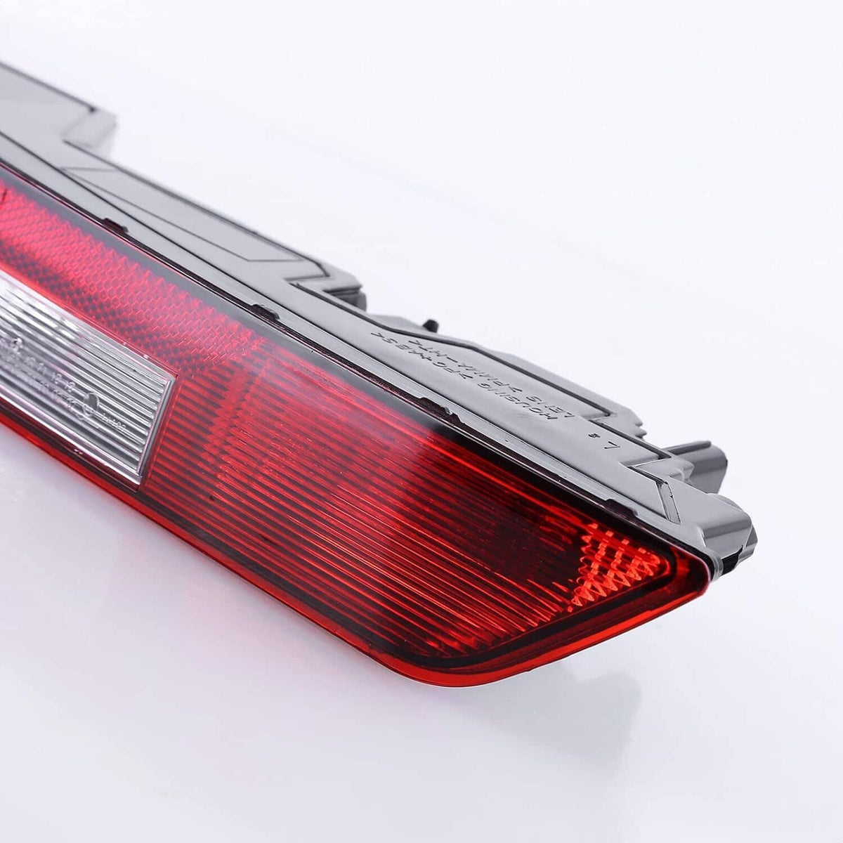 Red tail light with clear reflector section and black trim, angled view