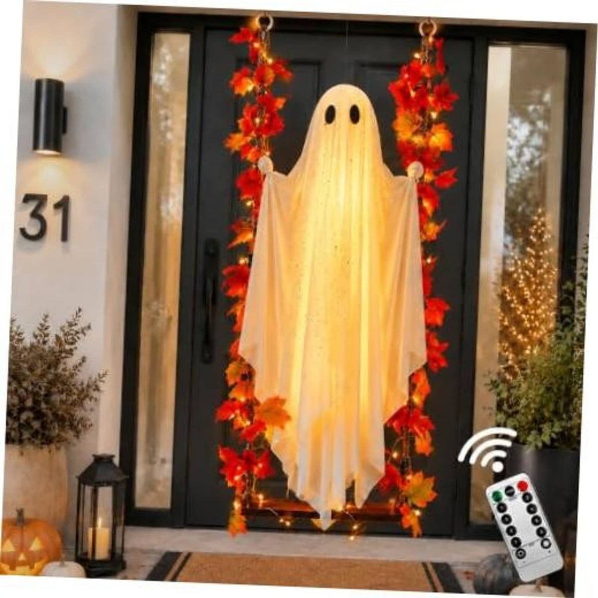 Hanging ghost decoration with warm white LED lights and red orange maple garland