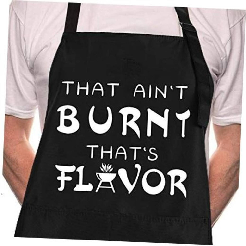 Black chef apron worn over a white shirt with large “That Ain’t Burnt That’s Flavor” print.