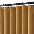 Gold linen-look shower curtain with black hanging hooks on top rod header