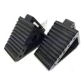 Pair of black solid rubber wheel chocks with ribbed tread and mounting holes