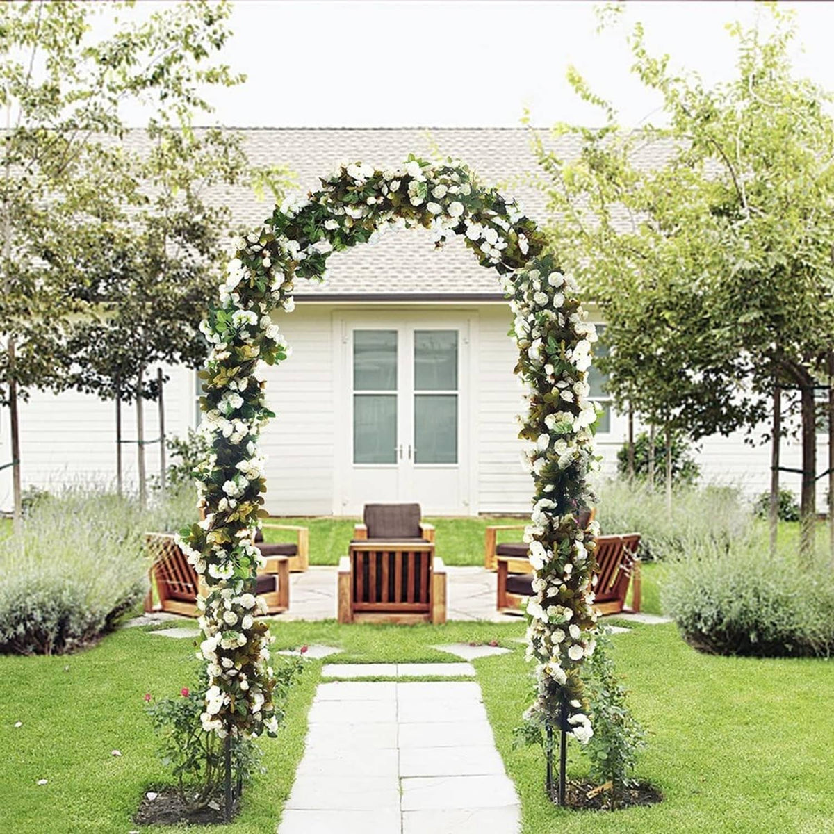 Outdoor garden arch trellis wrapped in white flowers for a backyard walkway
