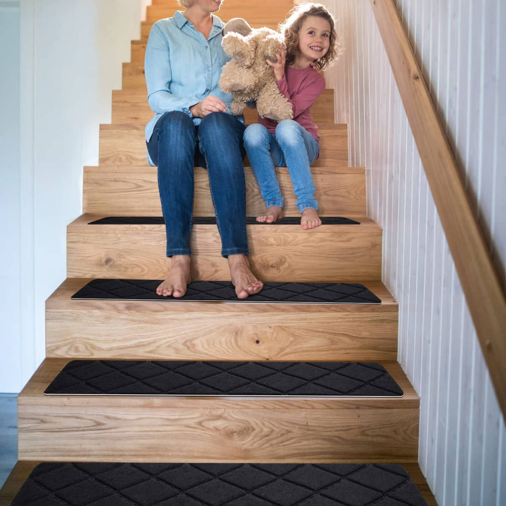 Black carpet stair treads with diamond pattern on wooden staircase with dog