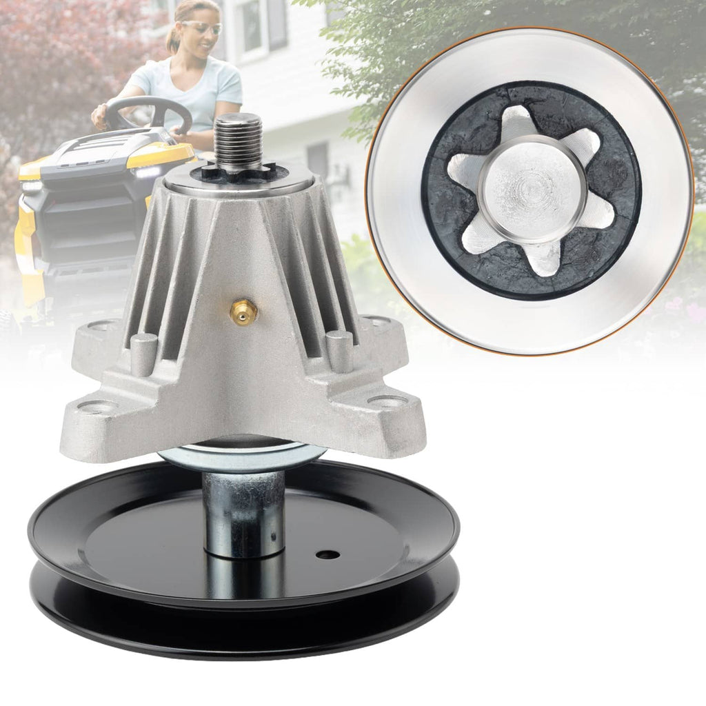 Deck spindle assembly with silver housing and black pulley, close-up of wheel hub