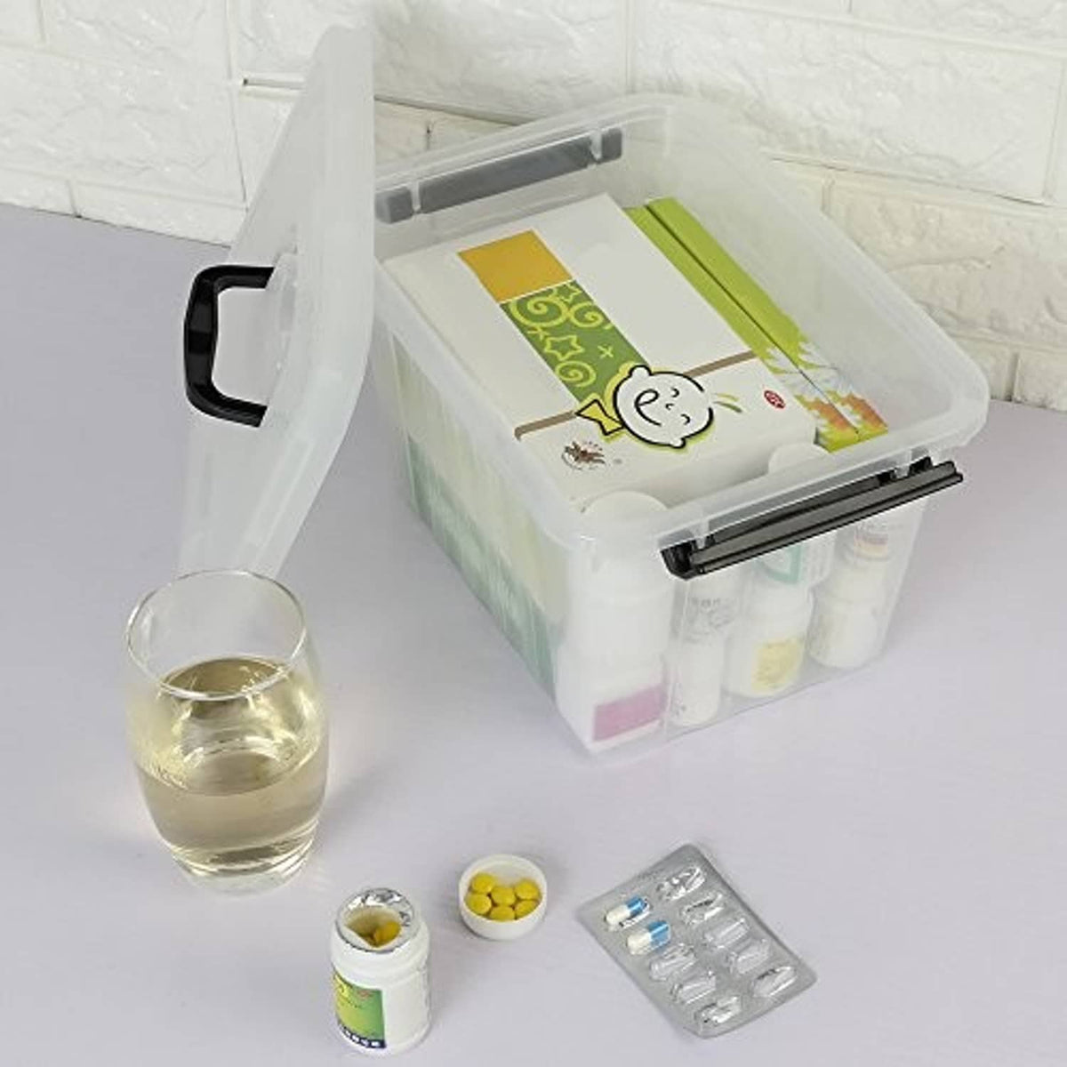 Clear 6-quart storage box with black latch handle, lid open showing items inside