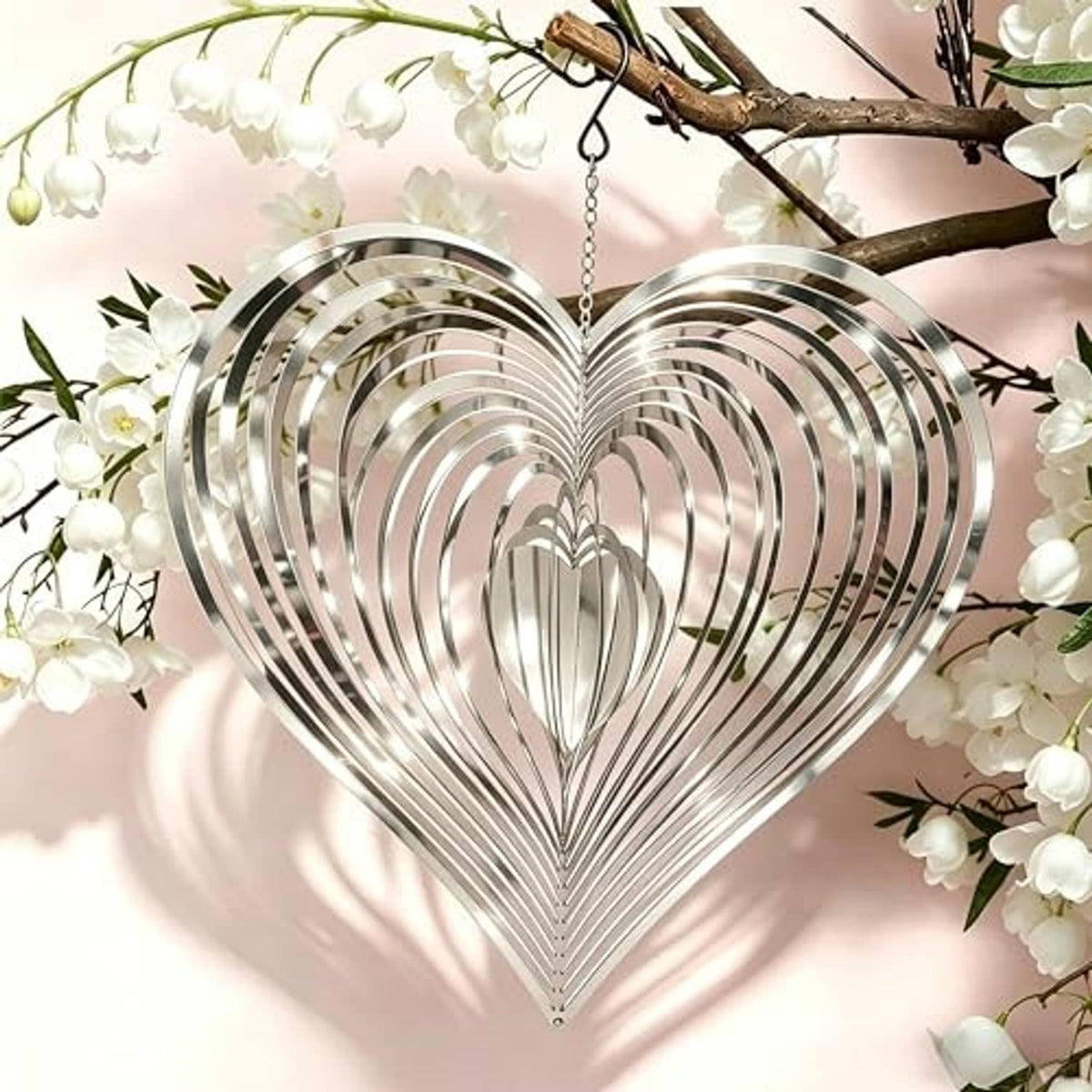 Reflective silver heart-shaped wind spinner with hanging chain and stacked metal strips