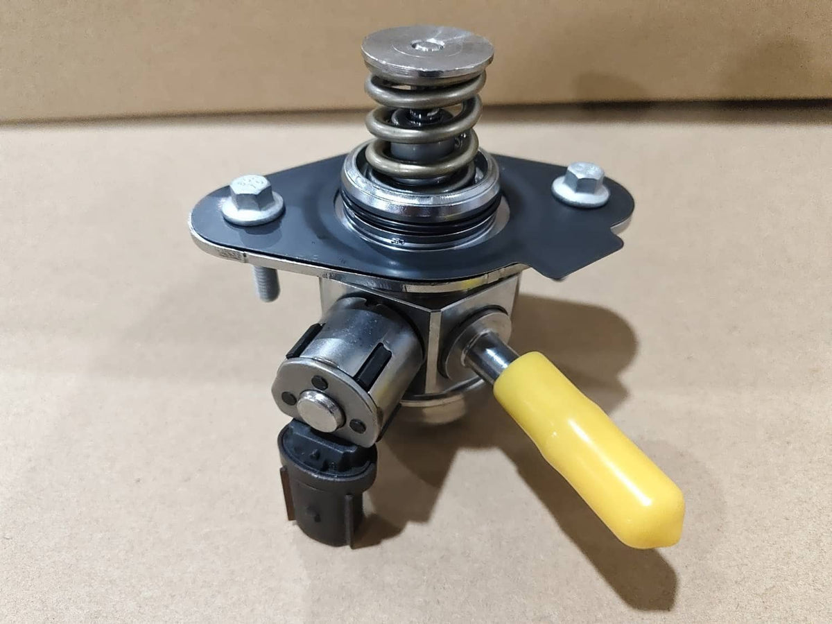 High pressure fuel pump with black housing and yellow lever, on a metal mounting plate