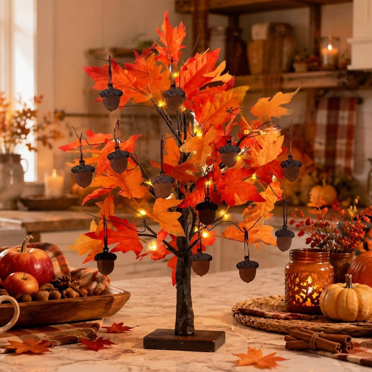 Orange fall centerpiece tree decoration with warm LED lights and hanging acorn ornaments