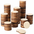 Unfinished round wood craft discs stacked in assorted piles, natural brown edges and light faces