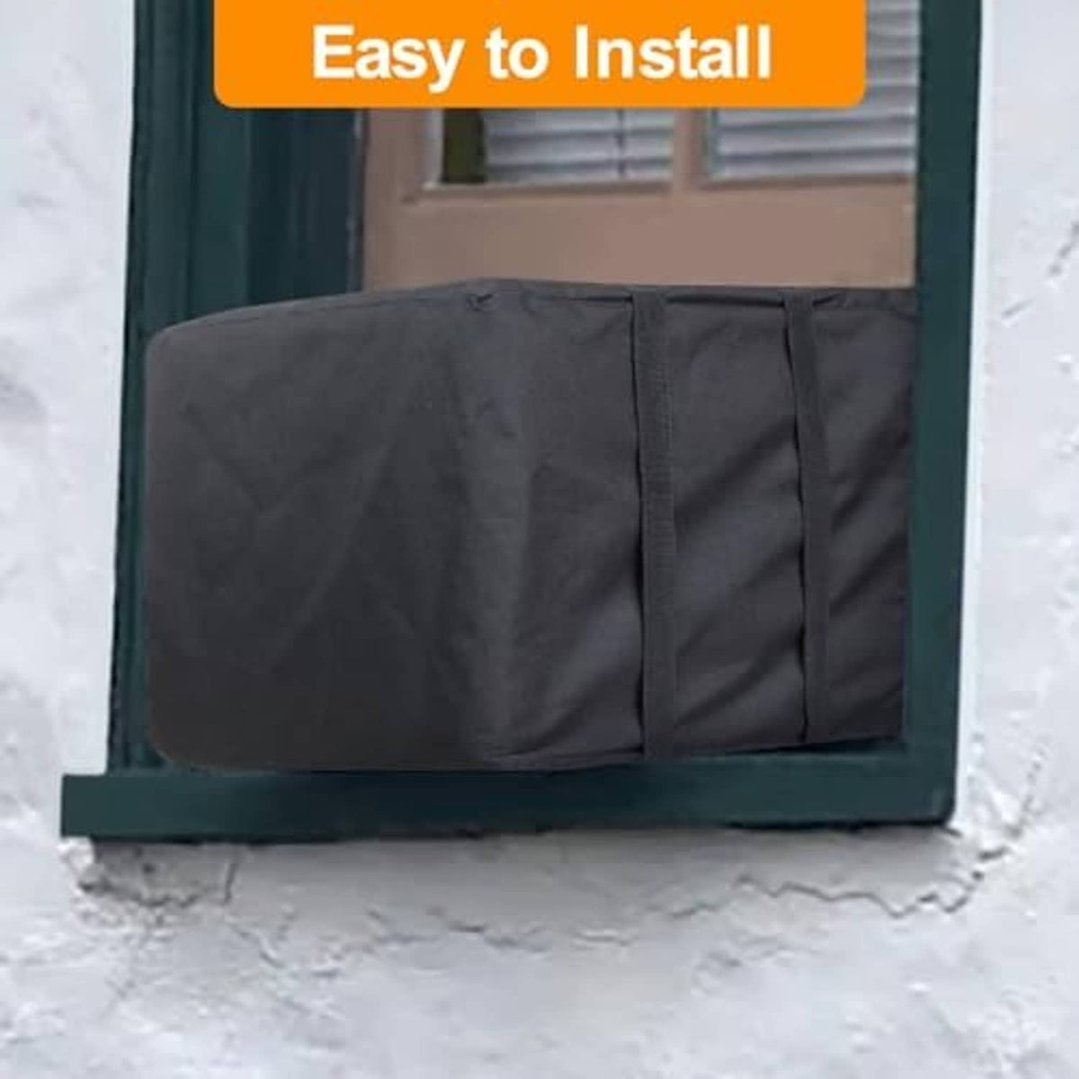 Outdoor AC cover fitted over a window unit in snow, dark fabric with side panels.