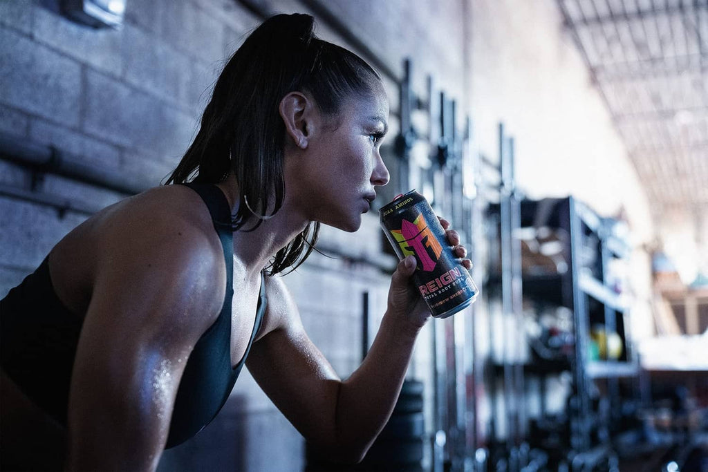 Reign fitness drink can (Reignbow Sherbet) held by athlete