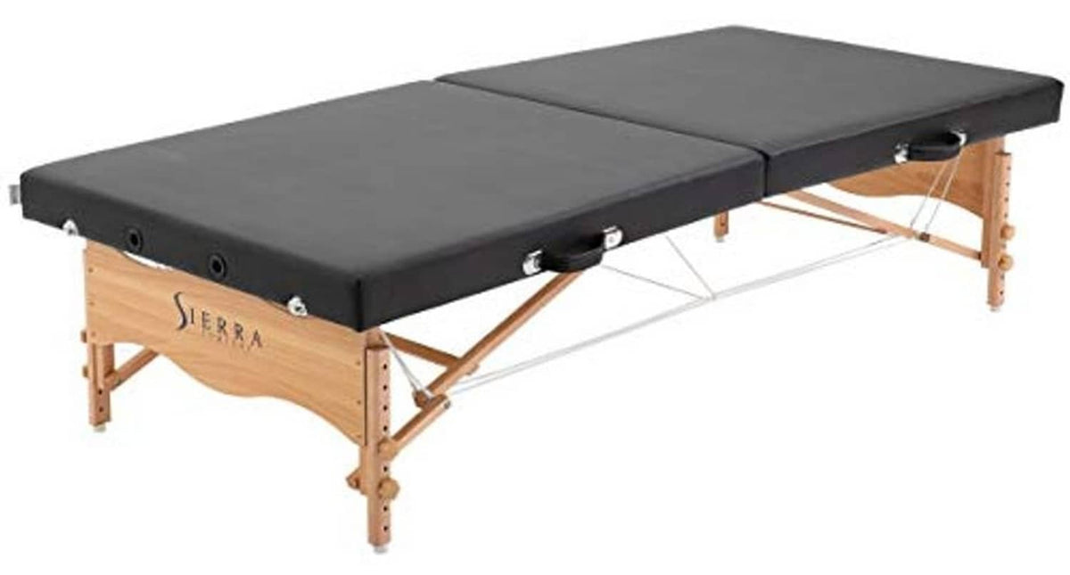 Black portable massage table with padded surface and wooden folding frame