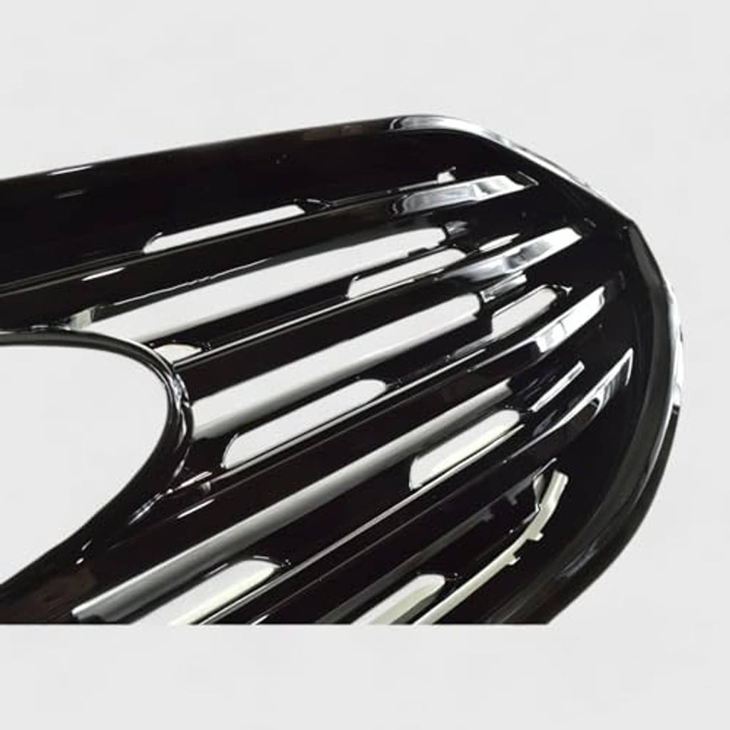 Close-up of gloss black grille overlay showing silver bar inlays and center round opening