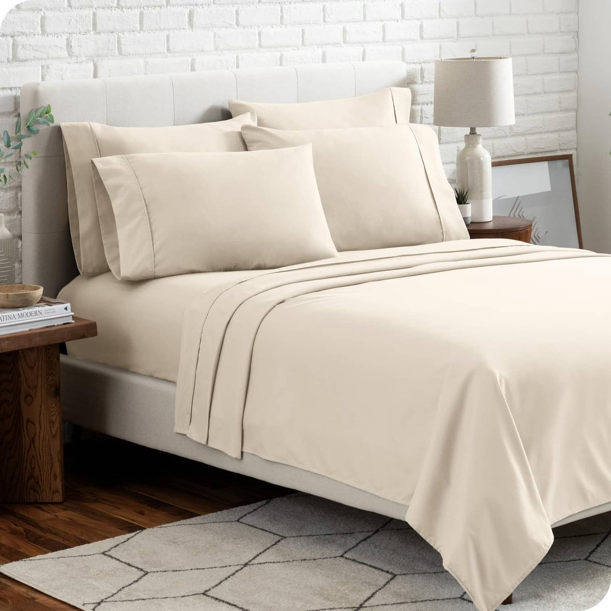 Cream microfiber split king sheet set with pillowcases and fitted flat sheet on bed