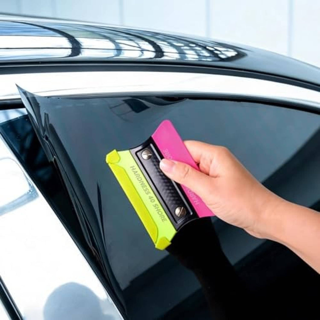 Neon green pre-cut squeegee felt buffer applicator on car window glass