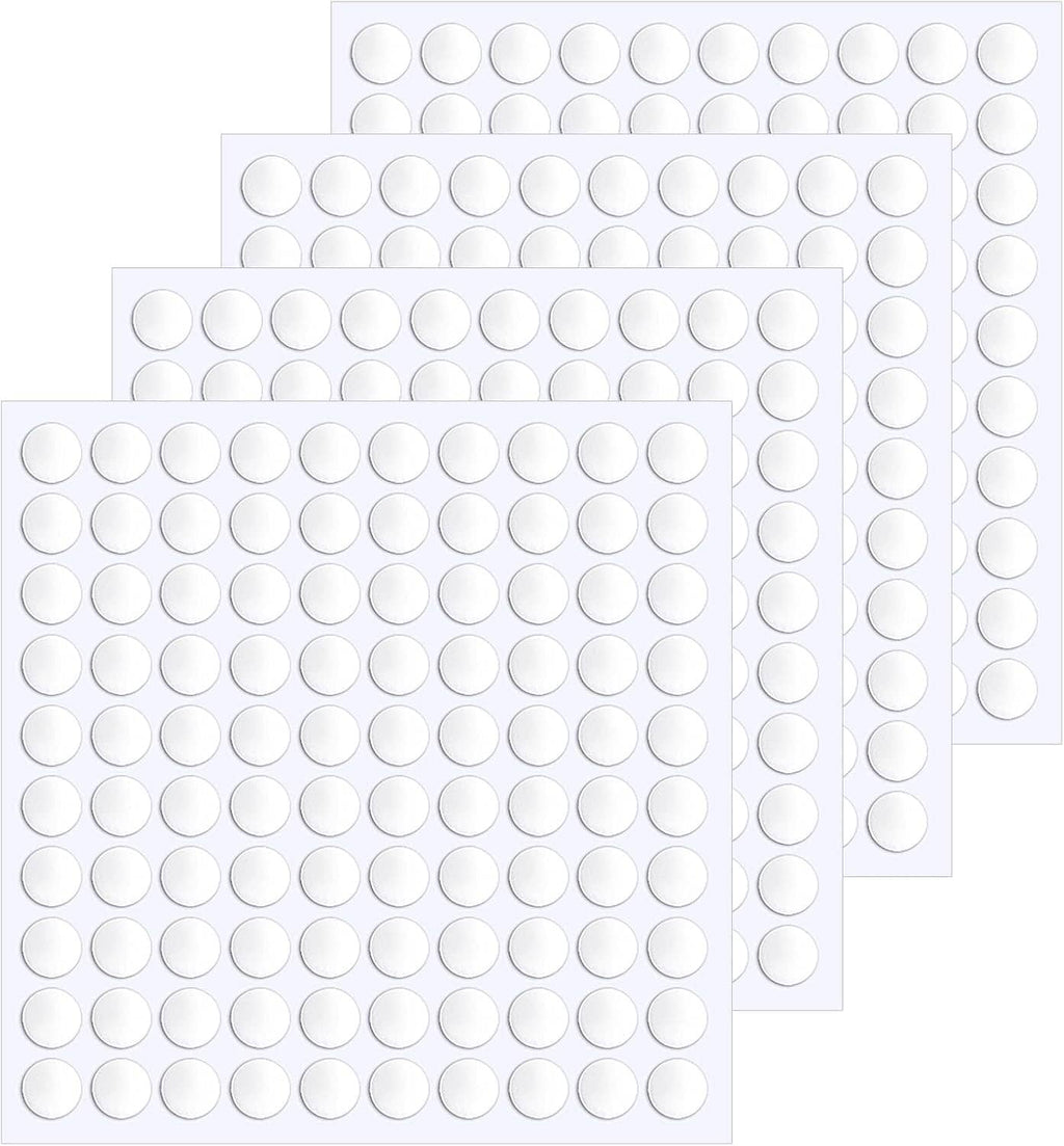 Stack of round double-sided adhesive dot sheets with clear pads on white backing