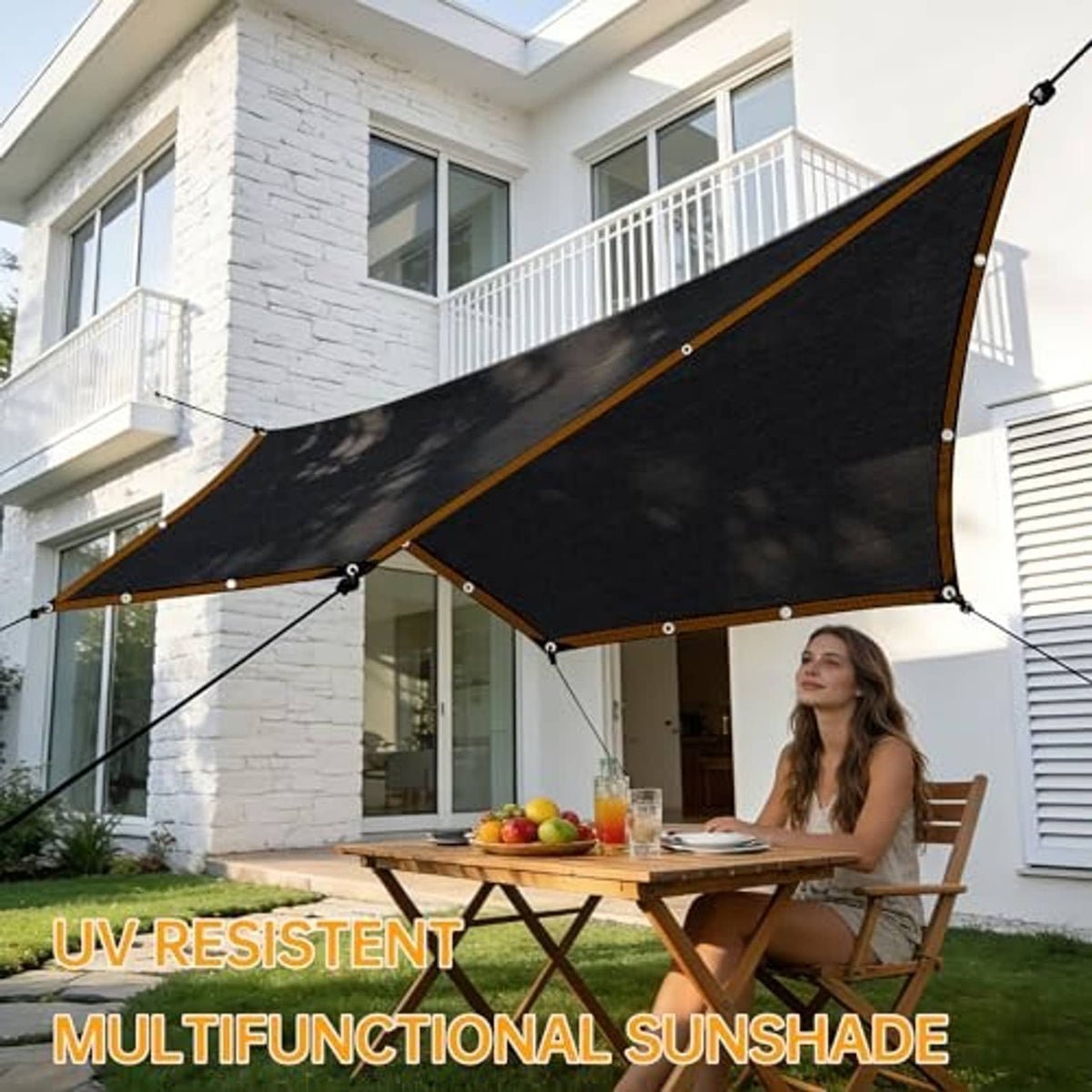 Black multipurpose mesh shade cloth stretched over an outdoor dining area frame.