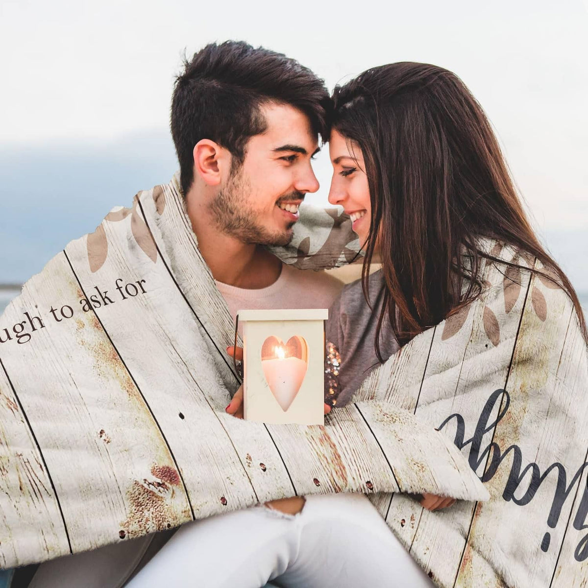 Beige marriage prayer throw blanket close-up with printed couple holding a candle and leaf motifs