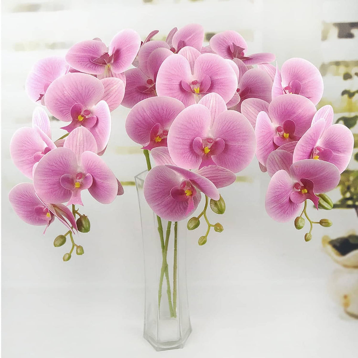 Pink artificial orchid stems with multiple flower heads, layered petals and yellow centers