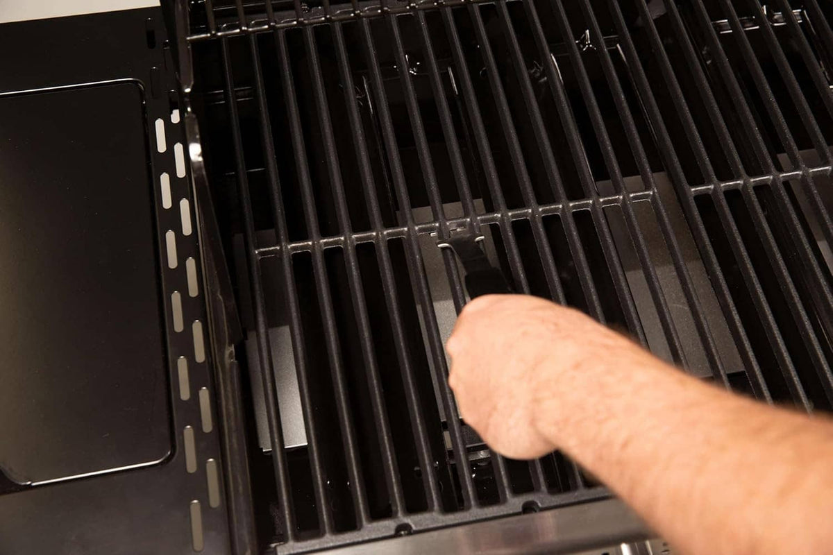 Barbecue grill grid lifter holding a grill grate section