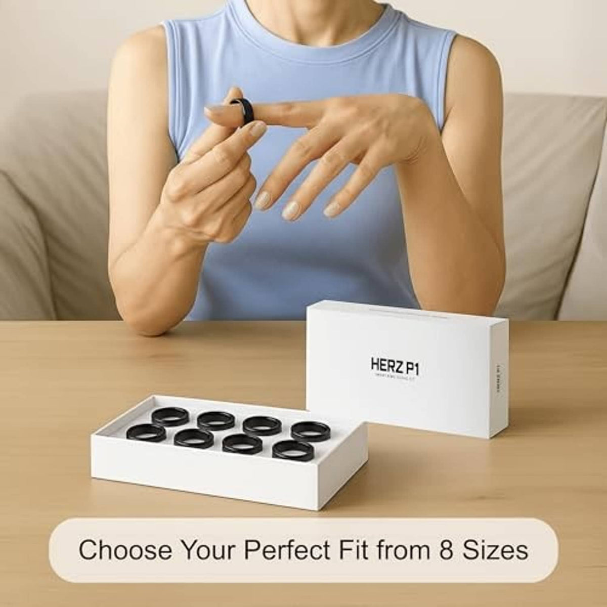 Person holding a black ring above a smart ring sizing kit box on table