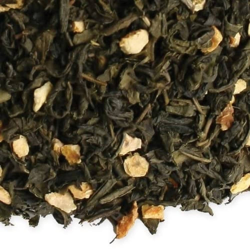 Close-up of dark loose tea leaves with light almond and orange bits