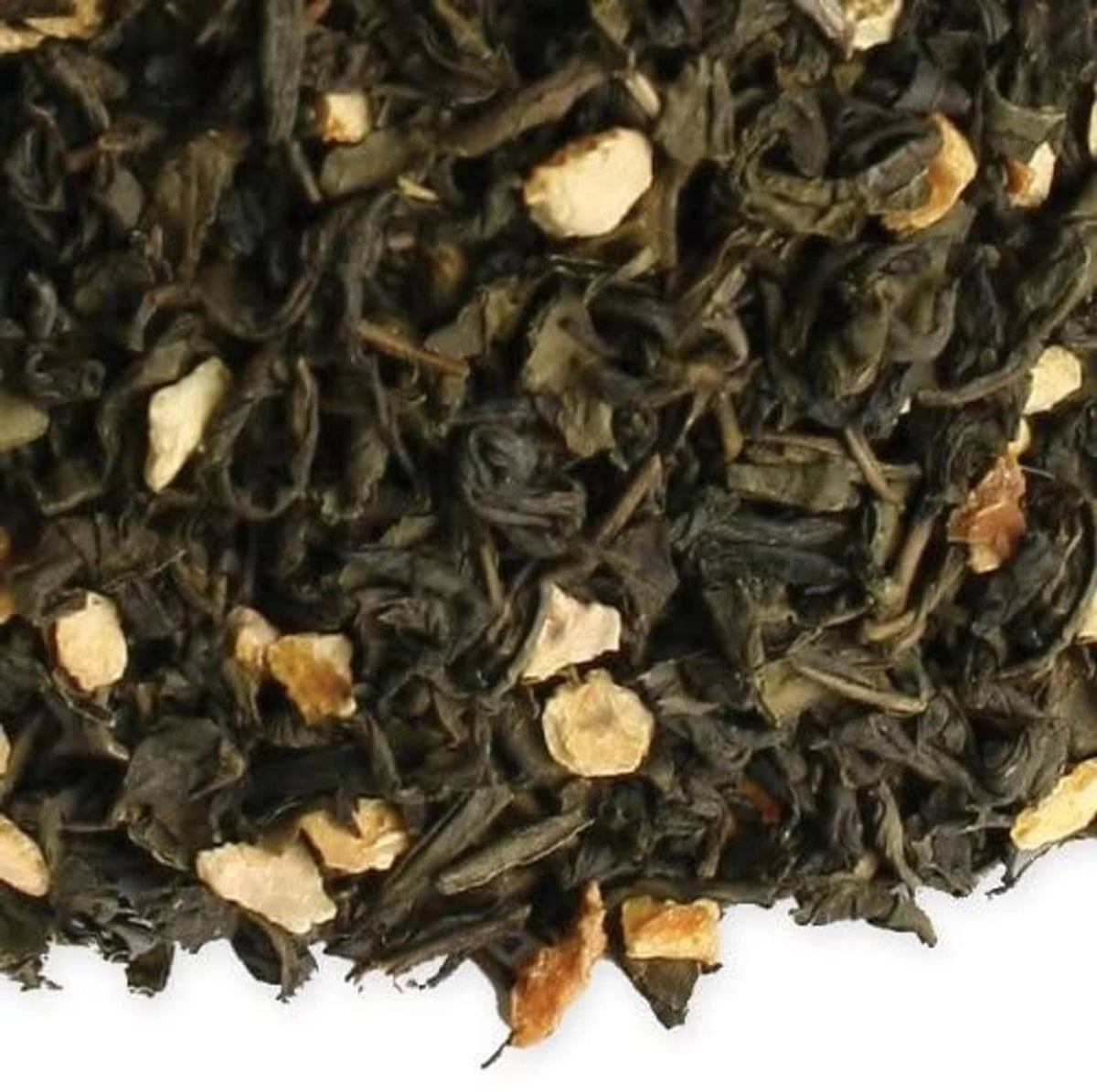 Close-up of dark loose tea leaves with light almond and orange bits