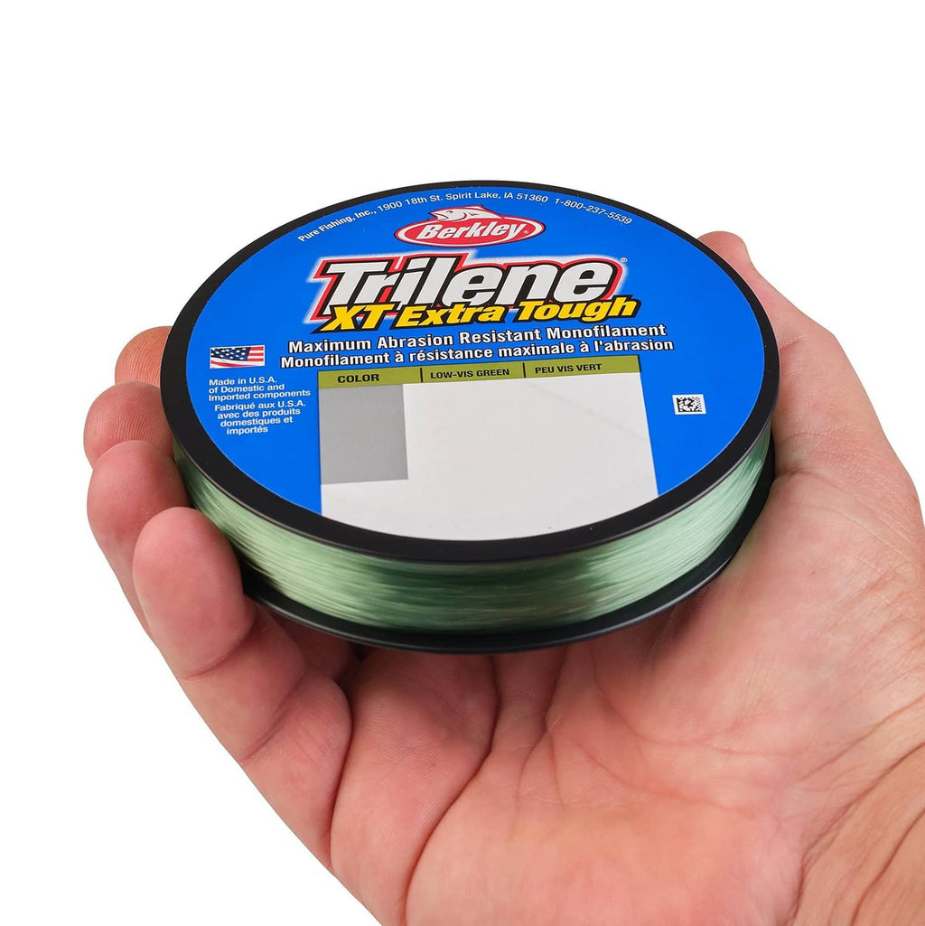 Spool of low-vis green monofilament fishing line held in a hand