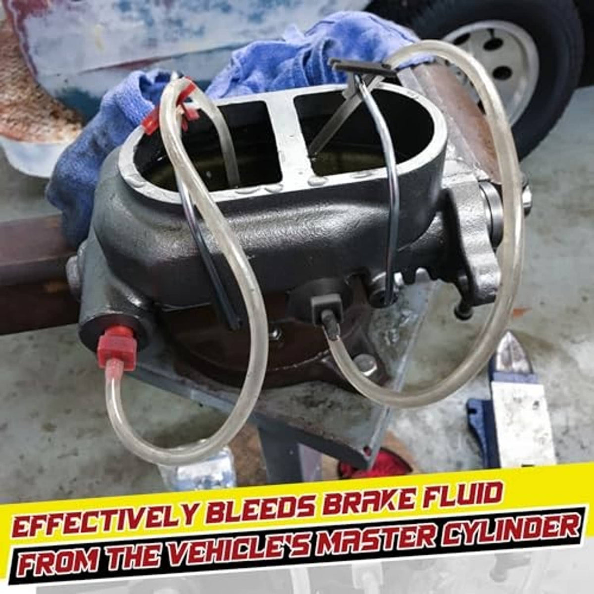 Brake master cylinder with attached clear bleeder hoses and red/black fittings