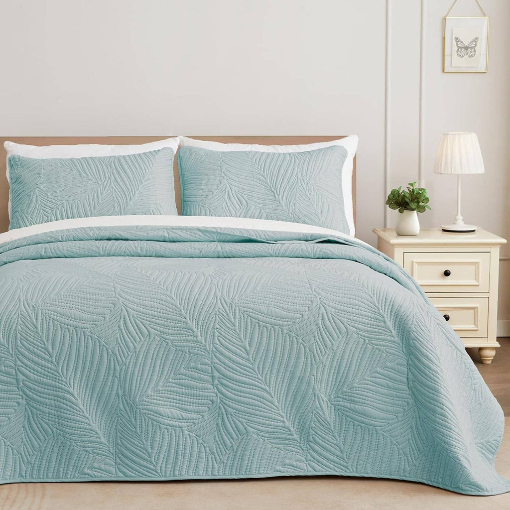 Aqua blue lightweight quilt with leaf-texture pattern and matching pillow shams