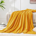 Yellow 3D ribbed jacquard fleece throw blanket, draped with textured ridges
