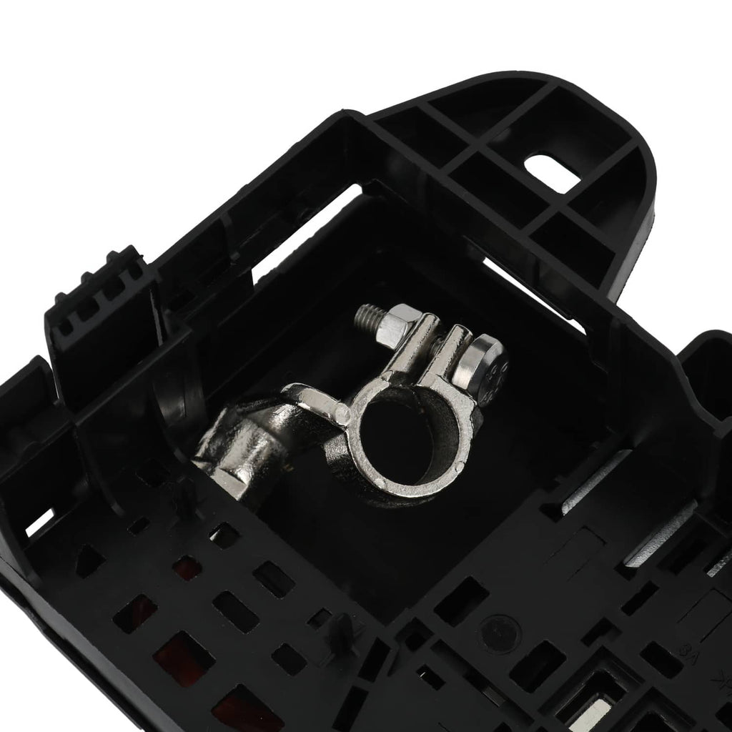 Black fuse block terminal top view showing circular metal terminal contact