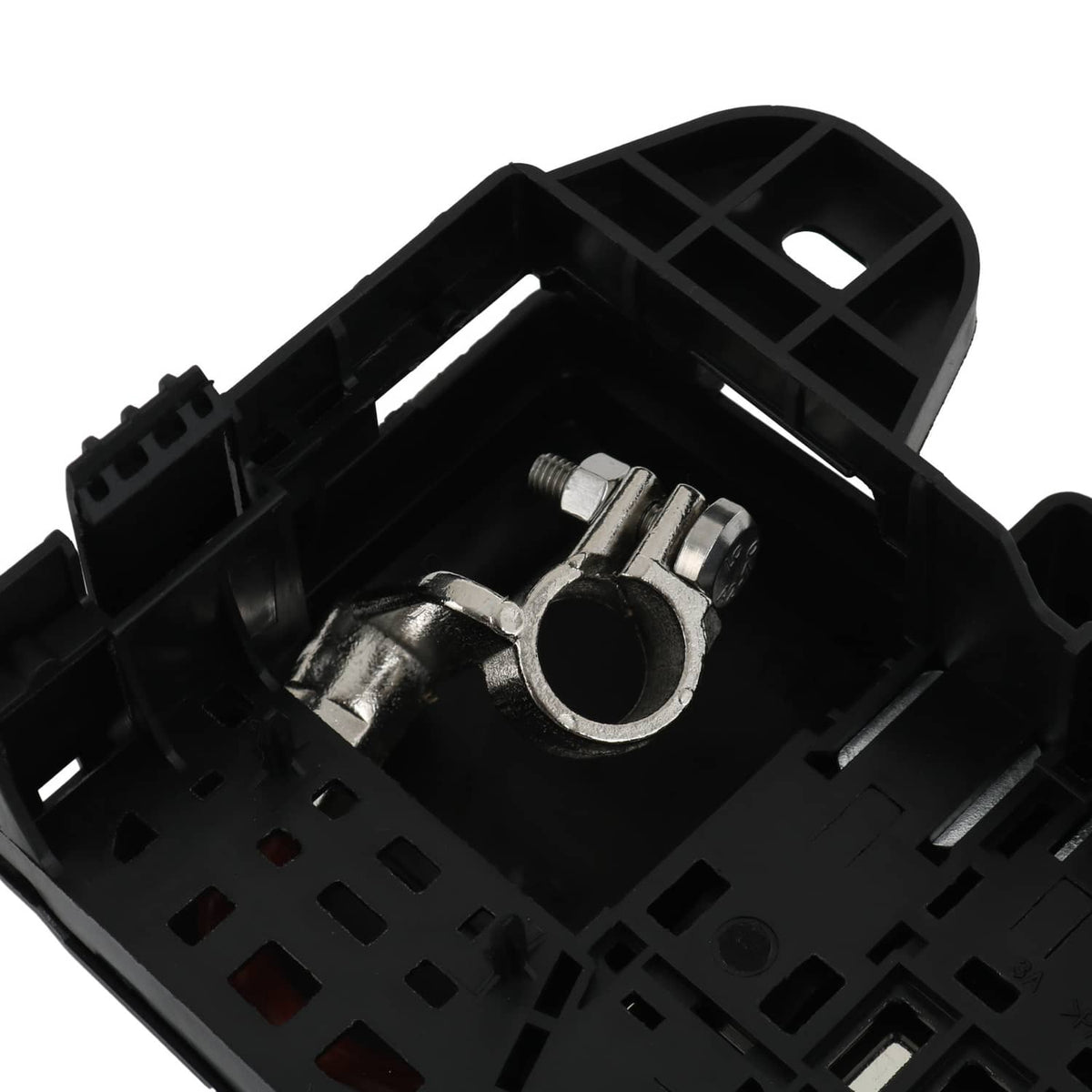 Black fuse block terminal top view showing circular metal terminal contact