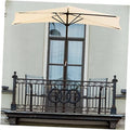 Tan half-round patio umbrella on balcony above wrought-iron railing