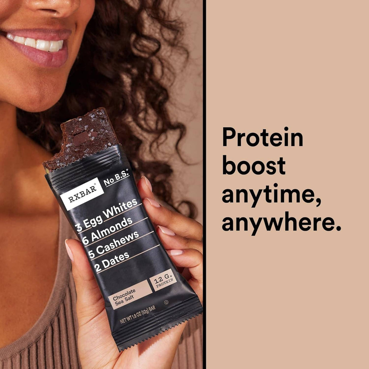 Hand holding a dark RxBAR protein bar packet labeled 12 g protein