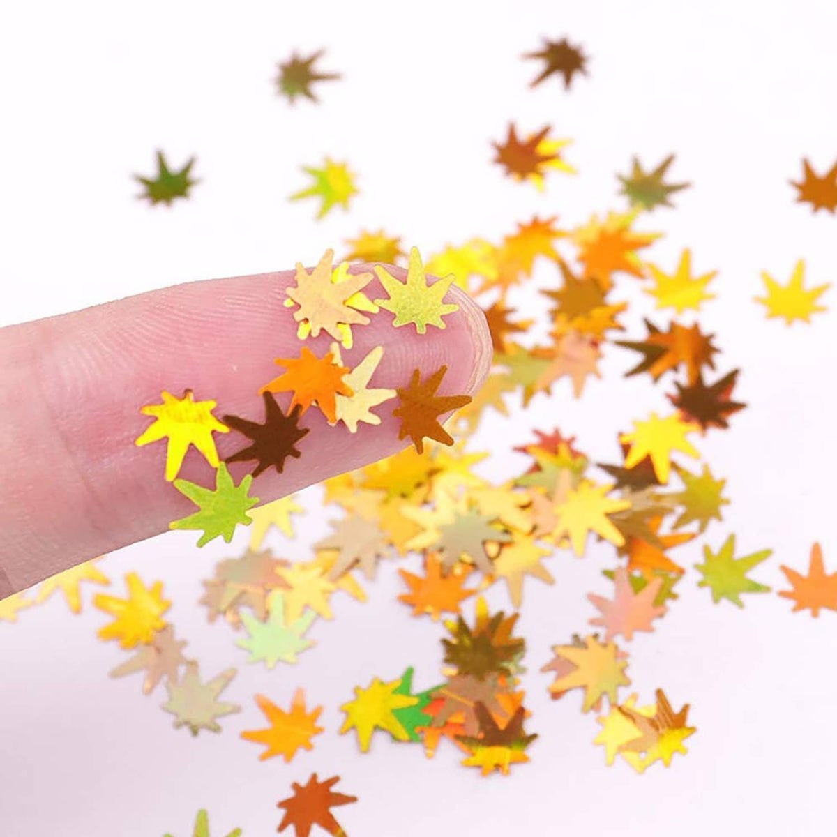 Close-up of yellow, orange, green maple leaf glitter sequins