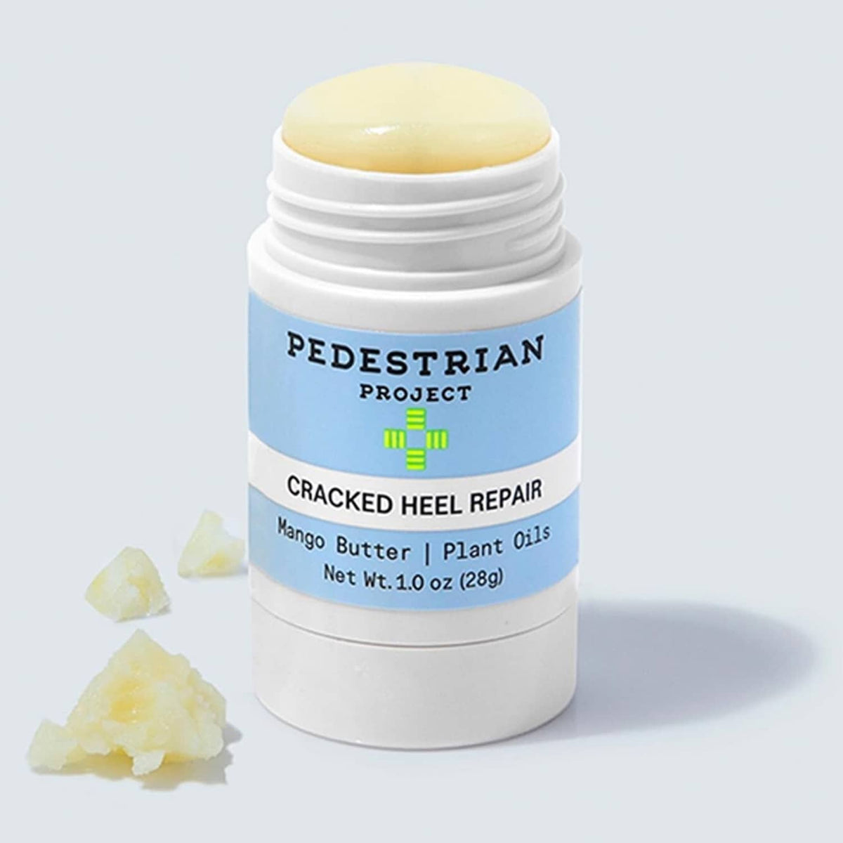 Cracked heel repair balm bottle with yellow balm top and blue label, white cap