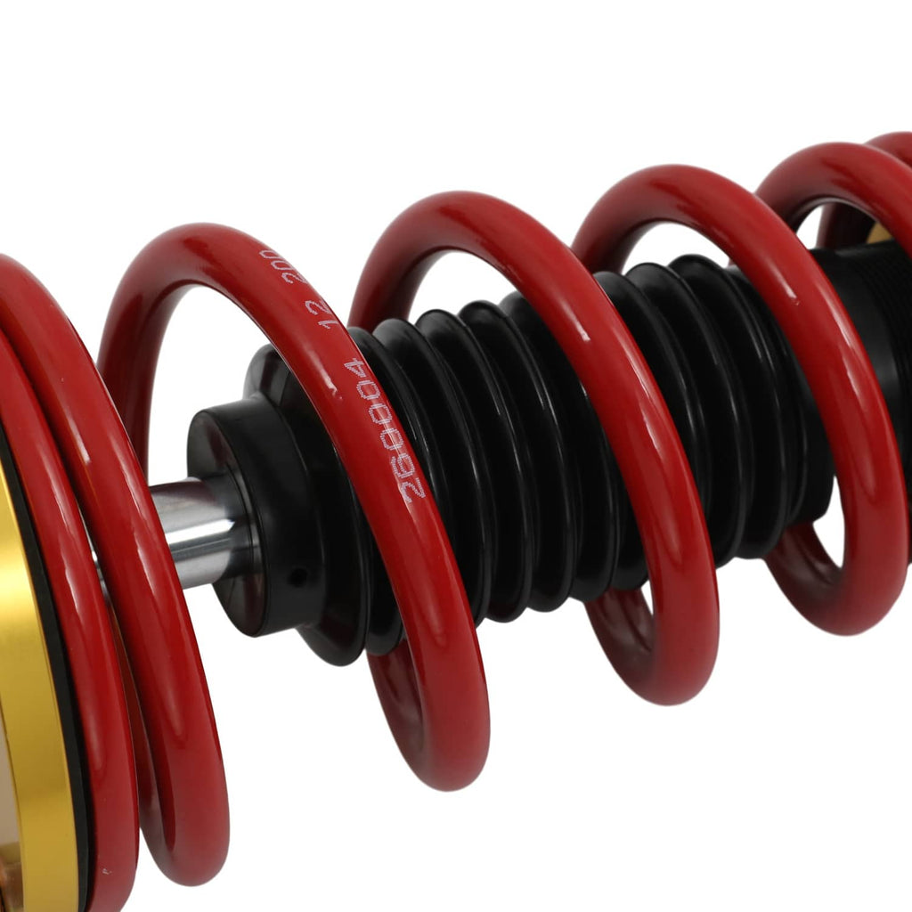 Close-up of red coil spring with black spring sleeves and central shaft