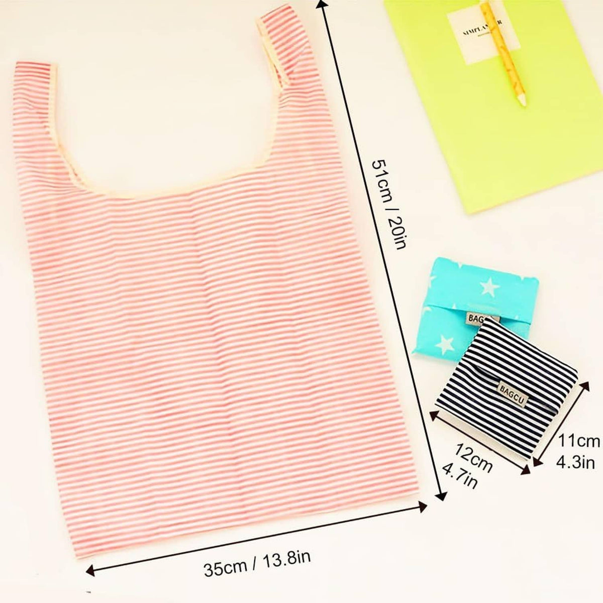 Foldable cloth tote bag with pink stripes shown with compact folded size profile