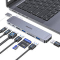 Gray USB-C hub adapter with several ports connected to a laptop