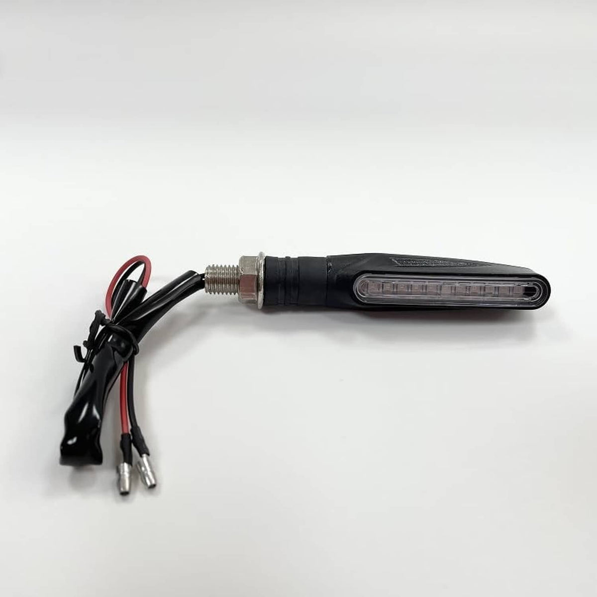 Black LED turn signal with amber lens and connected red/black power leads