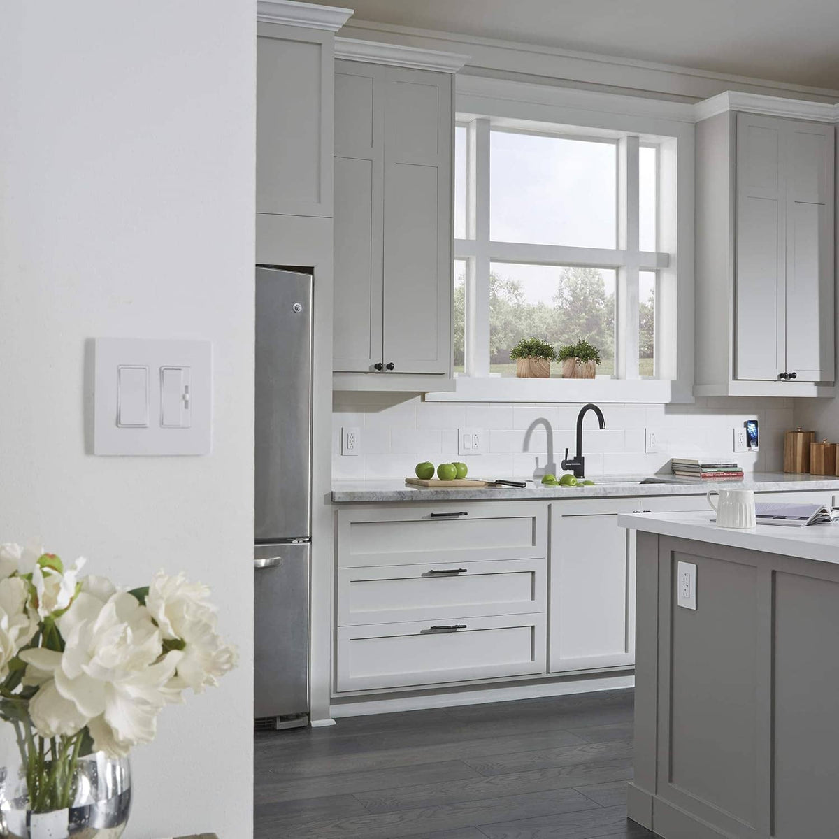 Gray wall-mounted light switch on the kitchen backsplash in a modern home