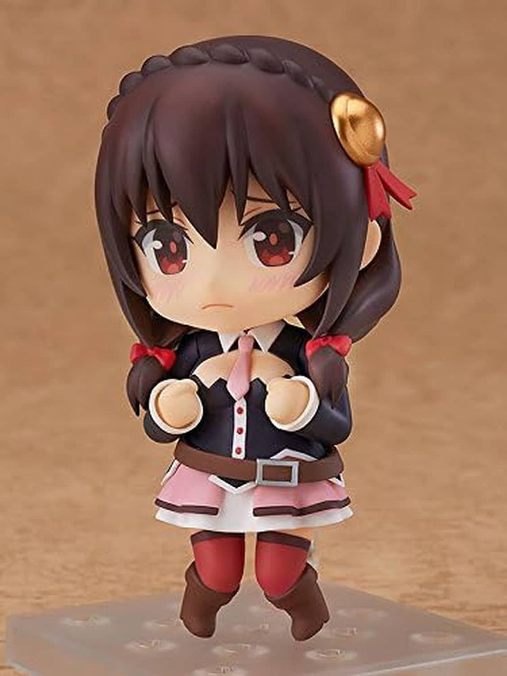 Chibi Nendoroid figure with dark hair, red eyes, pink skirt, fists raised, gold-horn hair accessory.