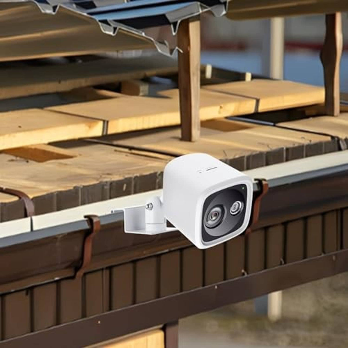 White gutter-mounted solar camera holder with bracket attached to the gutter