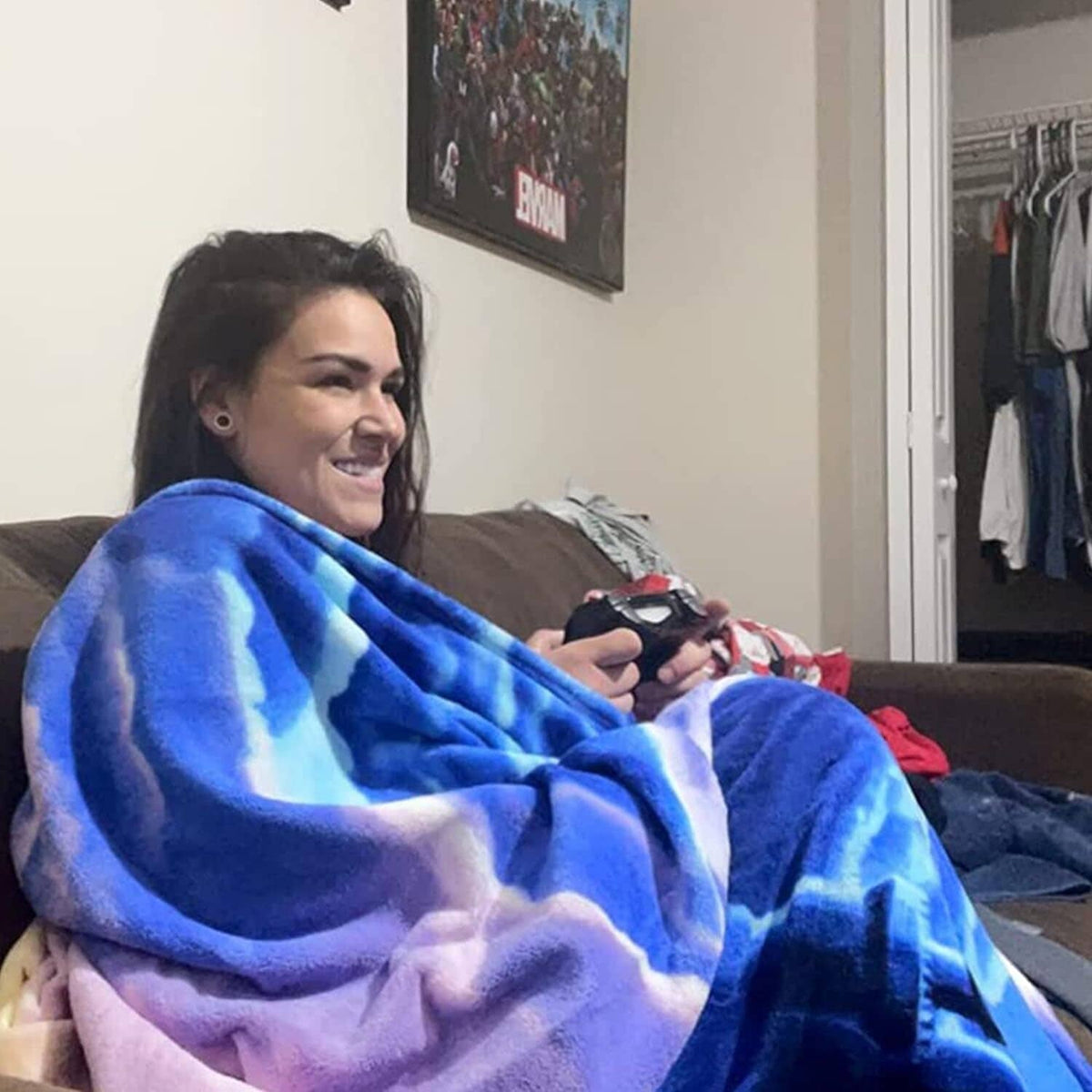 Blue and white unicorn plush blanket draped over a person’s shoulders