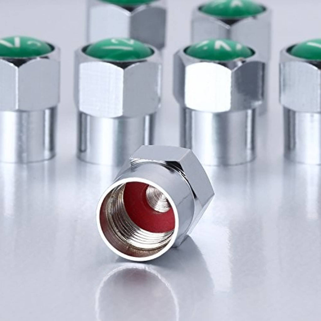Silver metal tire valve stem cap with green insert and visible threaded interior