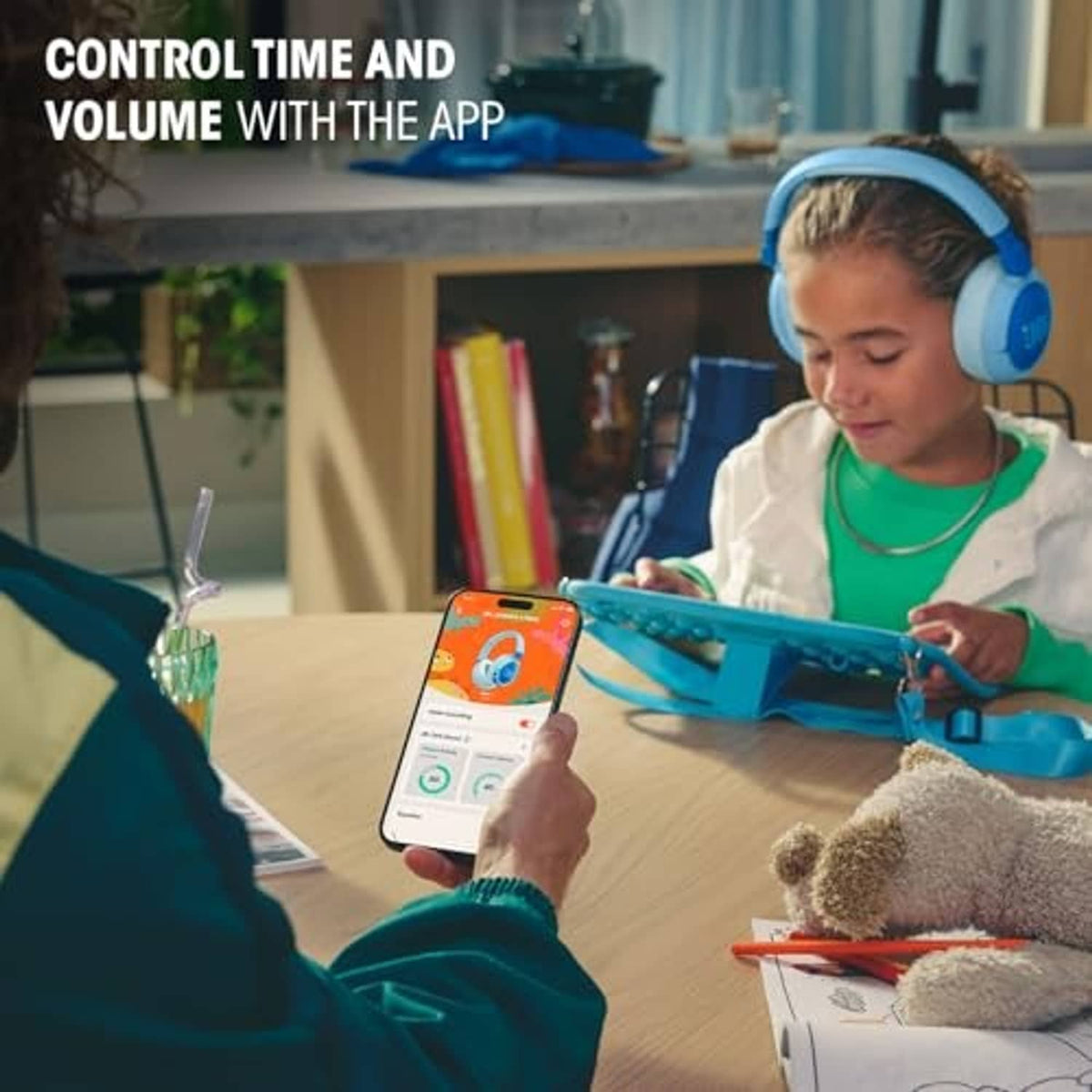 Kids using a tablet with white and gray over-ear JBL headphones.