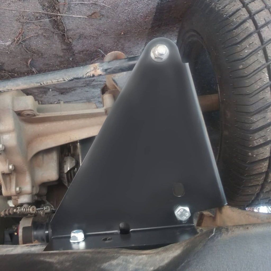 Triangular black mounting plate with bolt heads installed on front underside near tire