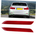 Pair of red rear bumper reflector light inserts, wedge-shaped with textured lens