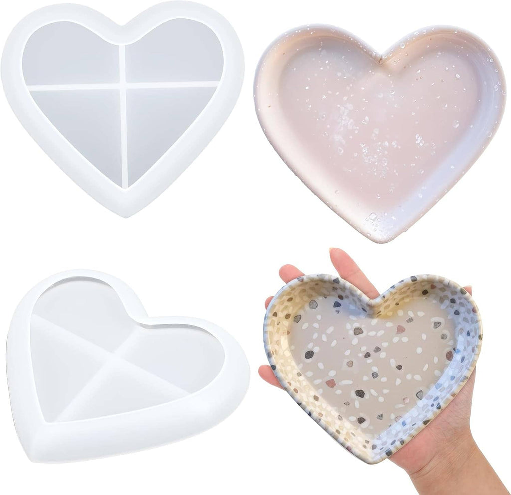 White heart resin molds shown with translucent pink tray and speckled heart tray in hand